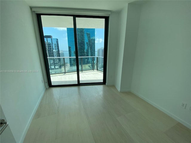 unfurnished room featuring floor to ceiling windows