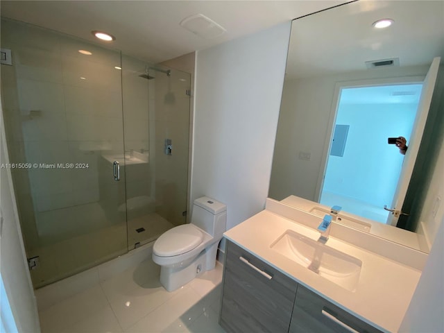 bathroom with toilet, tile patterned flooring, an enclosed shower, and vanity