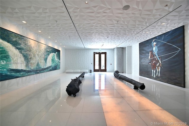 hall featuring french doors and tile patterned flooring