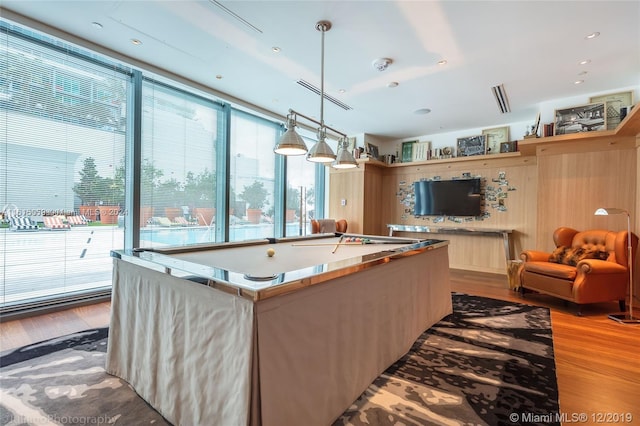 game room with light hardwood / wood-style flooring