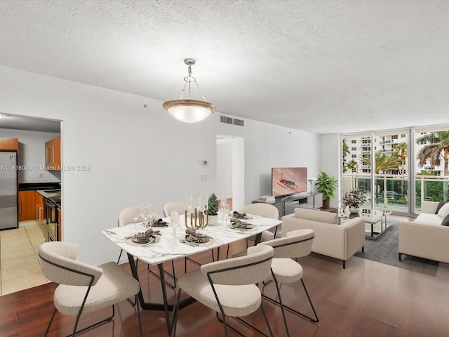 3000 S Ocean Dr Unit 206, Hollywood, FL 33019 - dining space with wood finished floors, a textured ceiling, and floor to ceiling windows