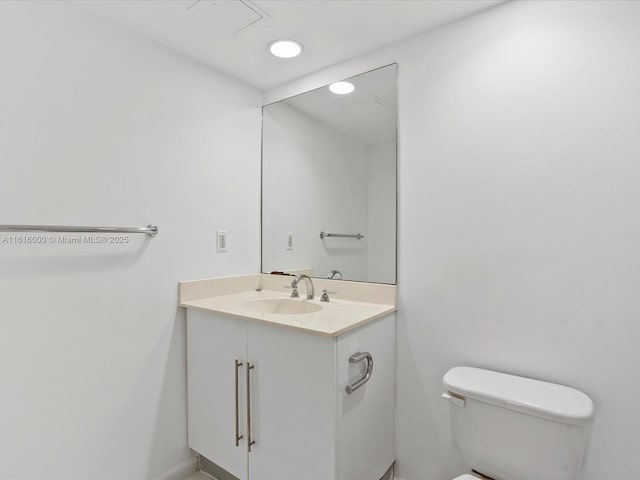 bathroom featuring toilet and vanity