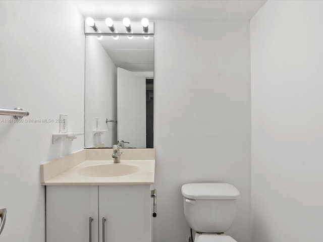 bathroom with toilet and vanity