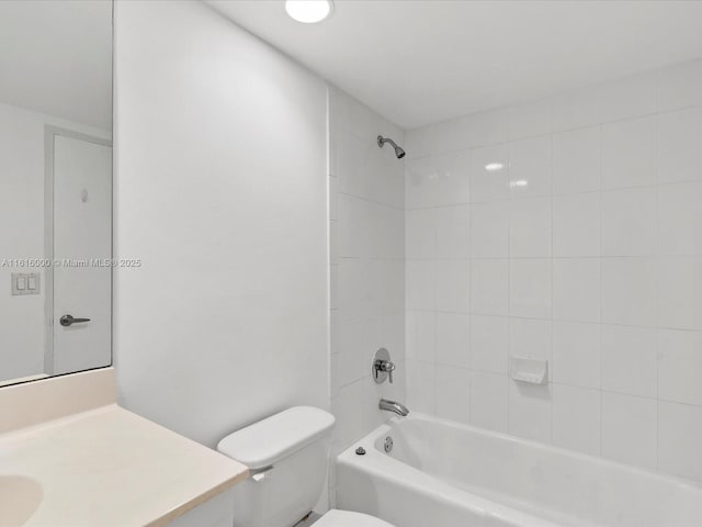 full bathroom with toilet, vanity, and tiled shower / bath