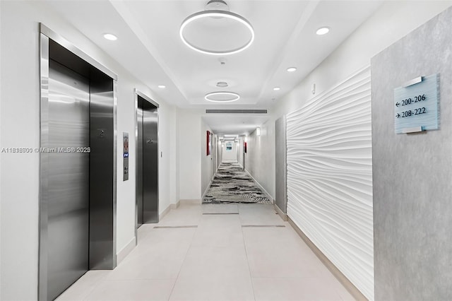 3000 S Ocean Dr Unit 206, Hollywood, FL 33019 - corridor featuring elevator, light tile patterned floors, recessed lighting, and a tray ceiling