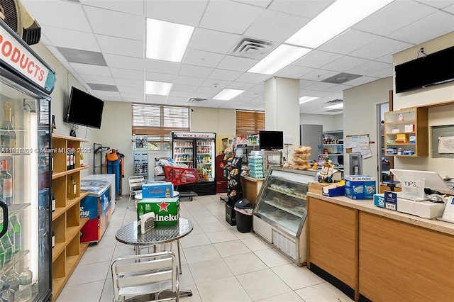 interior space with a paneled ceiling