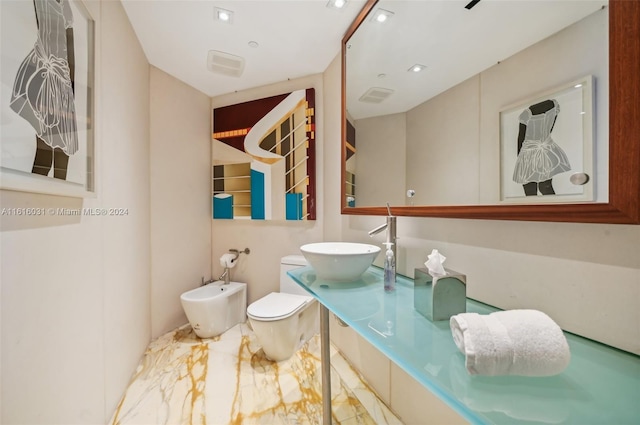 bathroom featuring a bidet, sink, and toilet