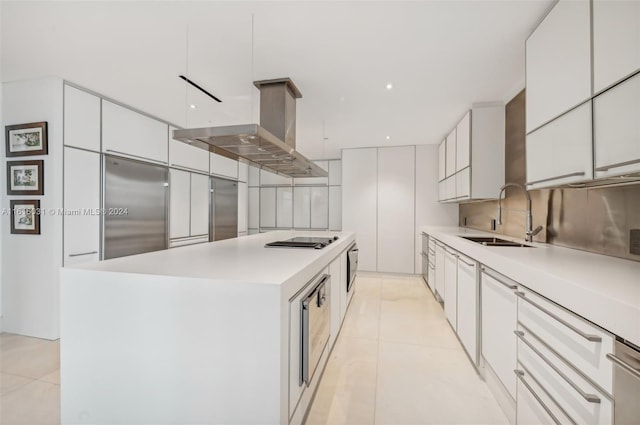 kitchen with white cabinetry, sink, a kitchen island, and appliances with stainless steel finishes