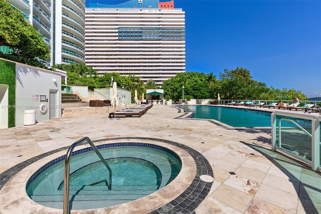 view of pool with a community hot tub and a patio area