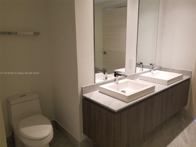 bathroom with tile patterned floors, toilet, and vanity