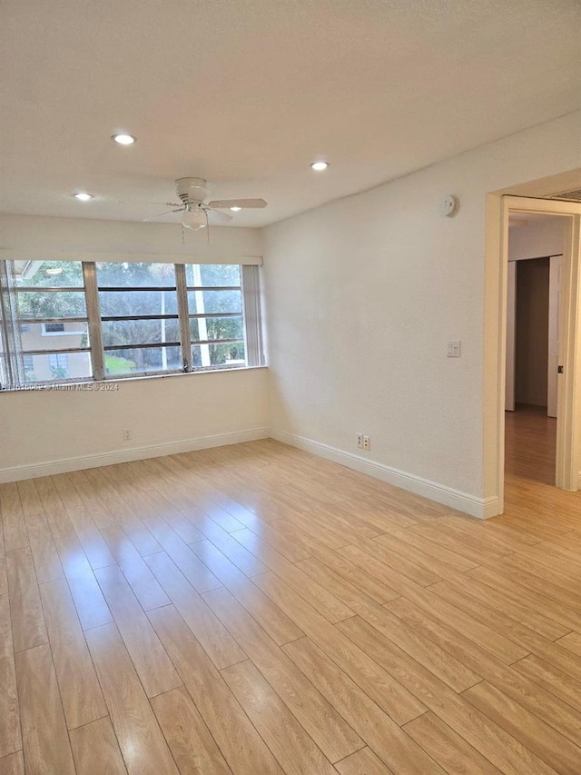 empty room with light hardwood / wood-style flooring and ceiling fan