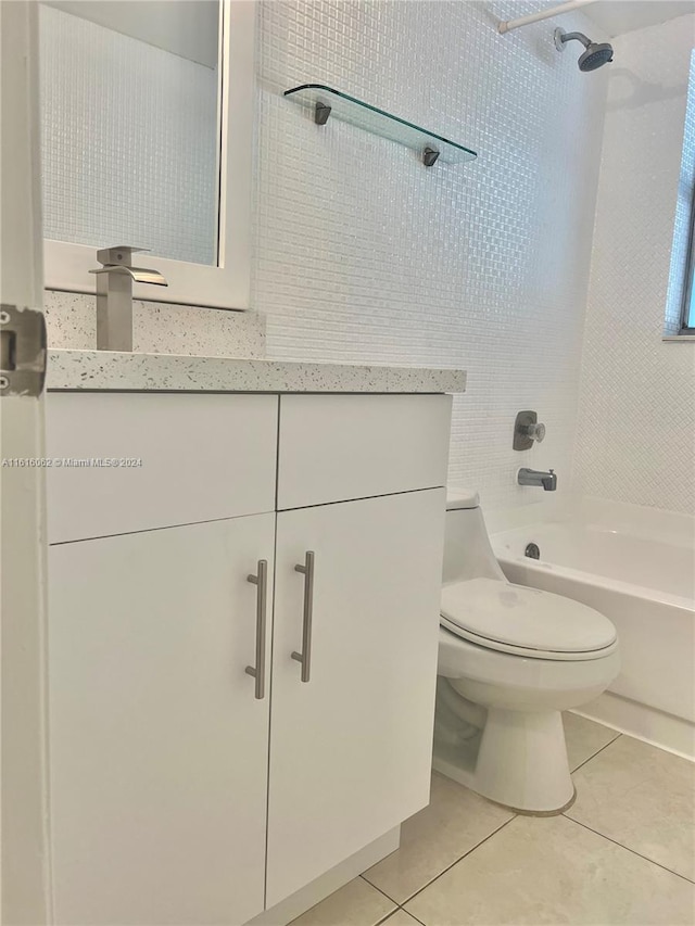 full bathroom featuring tile patterned floors, vanity, tiled shower / bath combo, and toilet