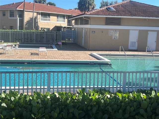 view of swimming pool with a patio