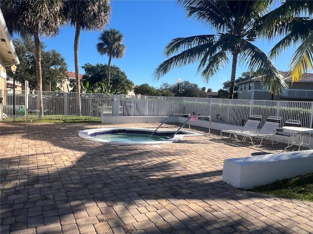 view of swimming pool featuring a patio area and a hot tub