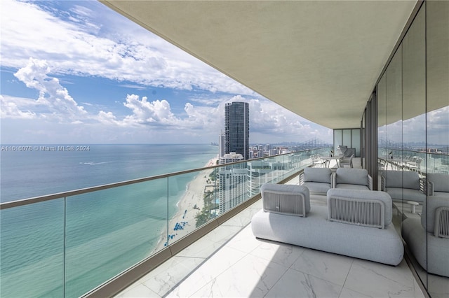 balcony featuring a water view and an outdoor living space