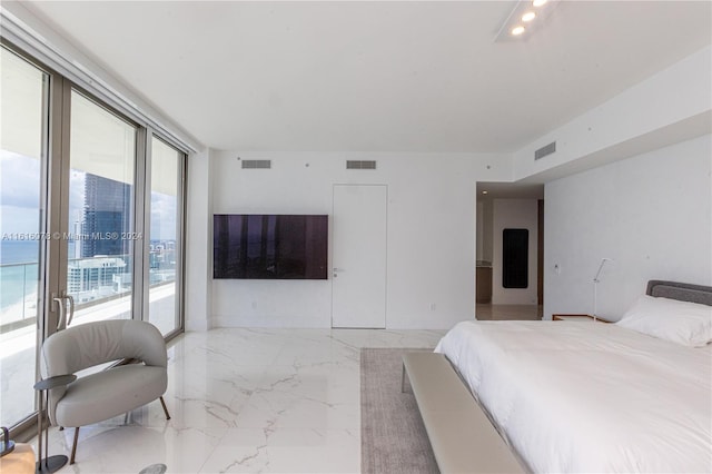 tiled bedroom with access to outside and floor to ceiling windows