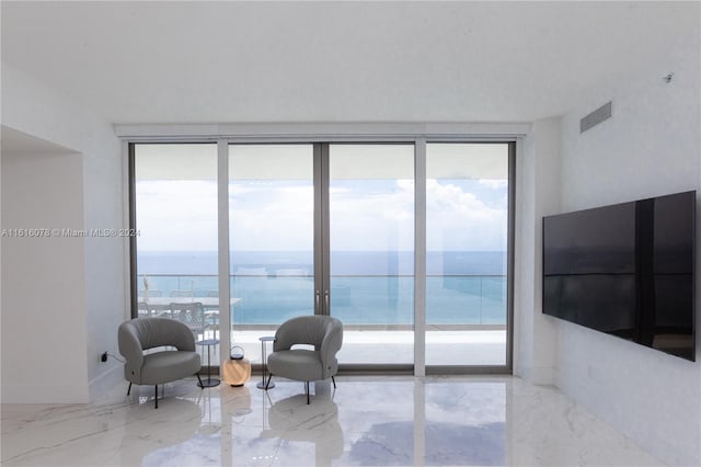 interior space featuring light tile patterned floors, a wealth of natural light, and a wall of windows