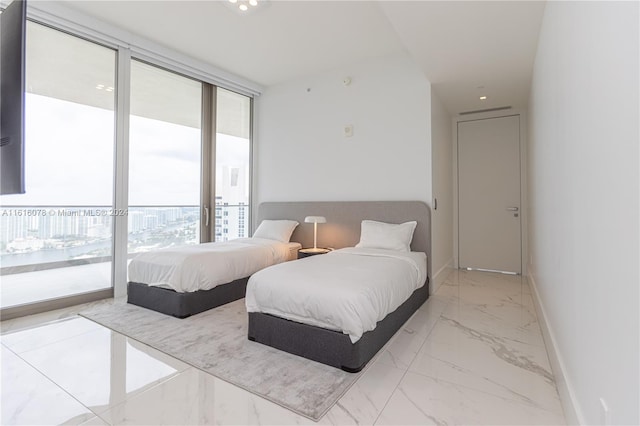 bedroom featuring light tile patterned flooring, expansive windows, and access to exterior