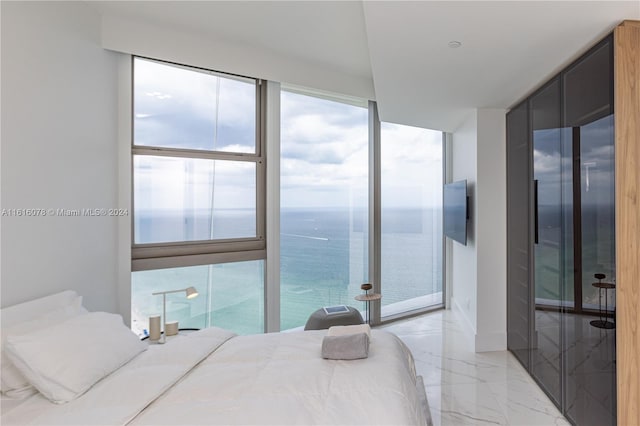 bedroom with light tile patterned flooring and floor to ceiling windows