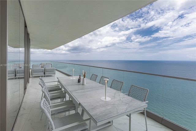 balcony featuring a water view and outdoor lounge area