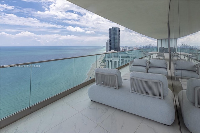 balcony featuring a water view and outdoor lounge area