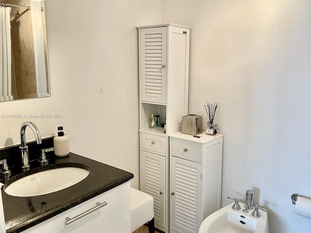 bathroom with a bidet and vanity