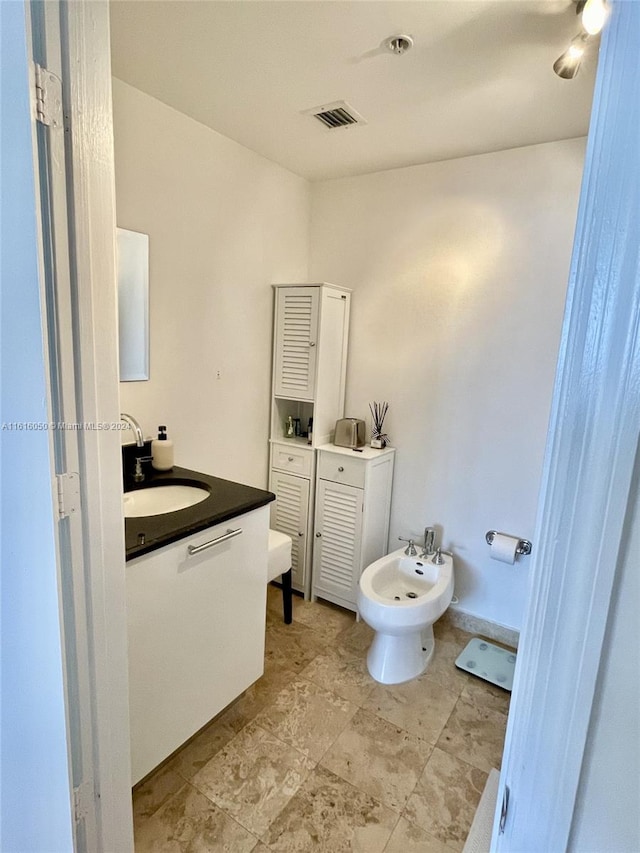 bathroom featuring vanity and a bidet