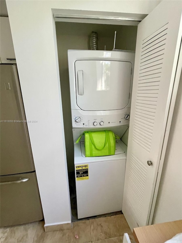 clothes washing area featuring stacked washer / dryer