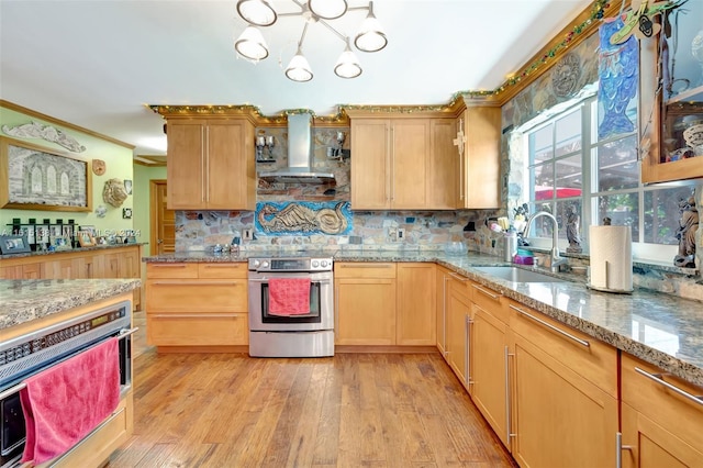 kitchen featuring light hardwood / wood-style flooring, crown molding, sink, wall chimney exhaust hood, and stainless steel appliances