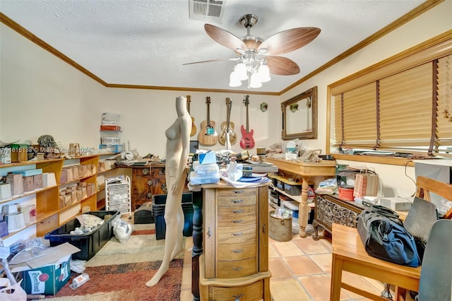 miscellaneous room with ceiling fan, a textured ceiling, light tile patterned flooring, and ornamental molding