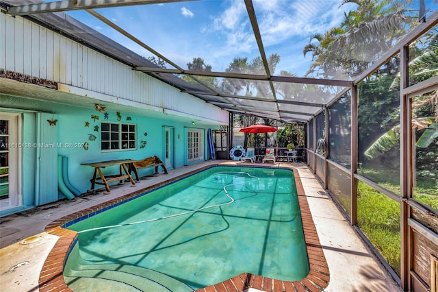 view of pool with a patio area and a lanai