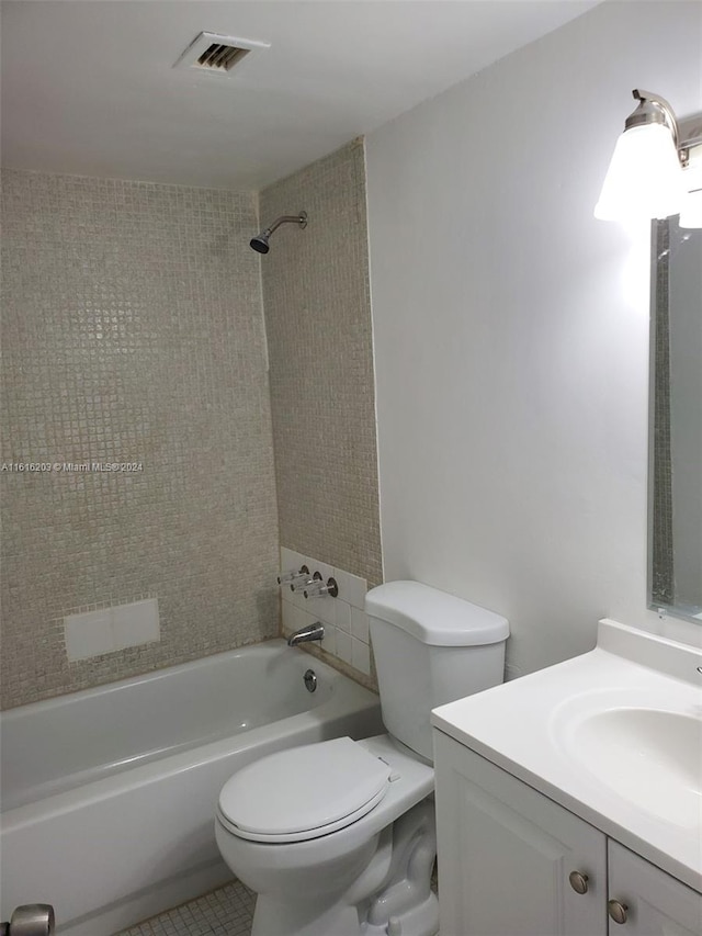 full bathroom featuring toilet, tiled shower / bath combo, tile patterned floors, and vanity