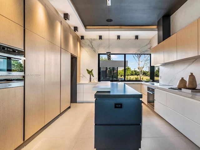 kitchen featuring a center island, oven, a wealth of natural light, and exhaust hood