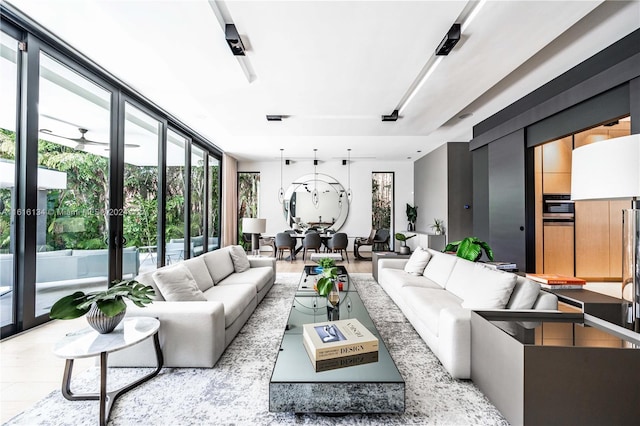 living room with light hardwood / wood-style floors and ceiling fan