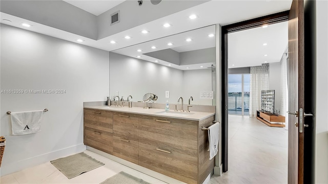 bathroom featuring tile patterned flooring and vanity