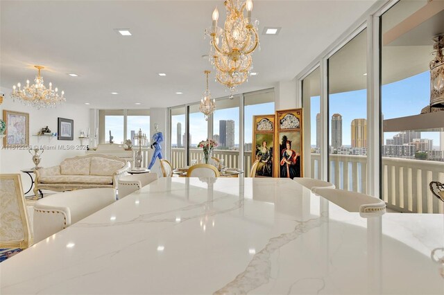 dining room with expansive windows and a chandelier