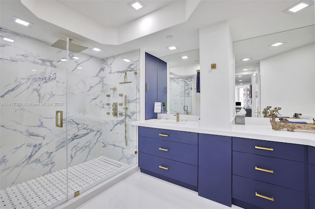 full bathroom featuring vanity and a marble finish shower