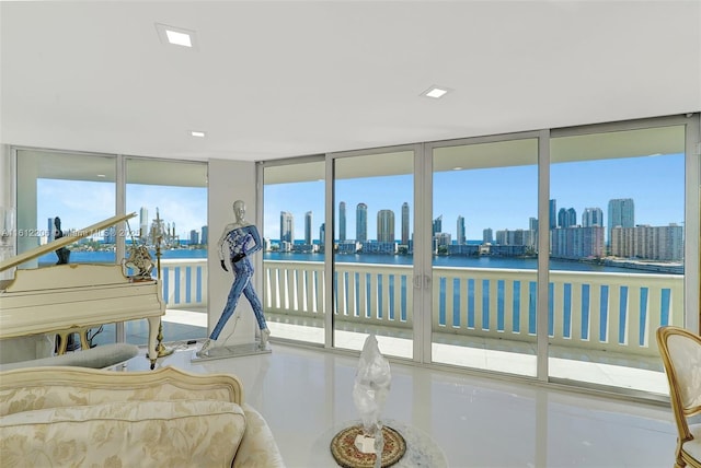 sunroom / solarium with a view of city and a water view