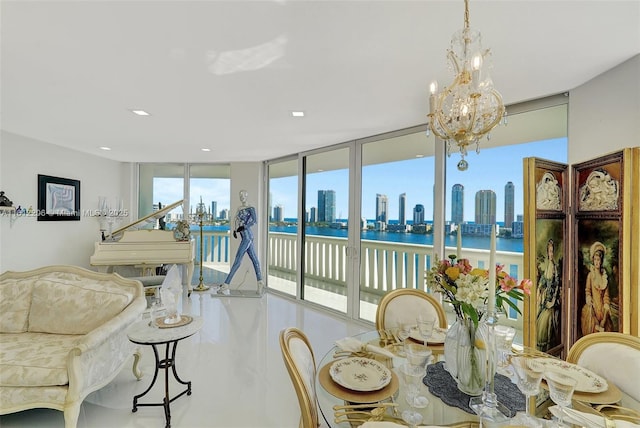 dining space with expansive windows, a water view, a view of city, and an inviting chandelier