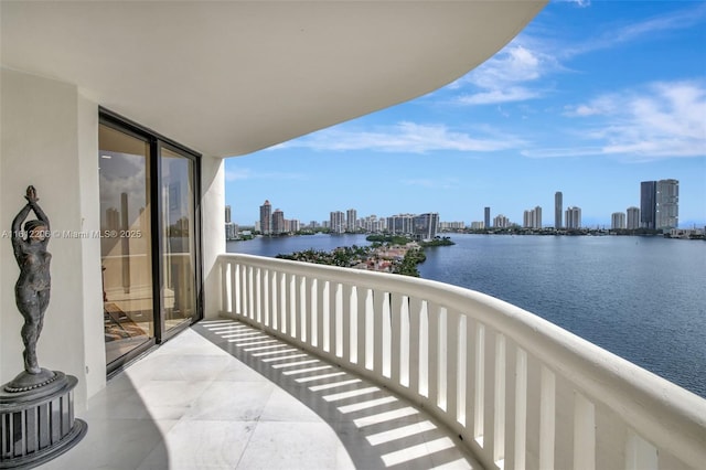 balcony featuring a view of city and a water view