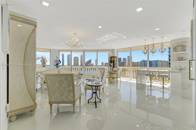 living room with a city view, an inviting chandelier, and floor to ceiling windows