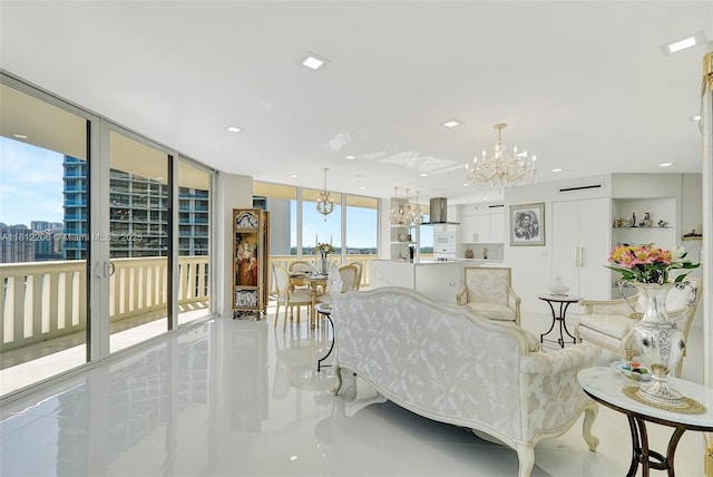 living room with expansive windows, recessed lighting, an inviting chandelier, and a city view