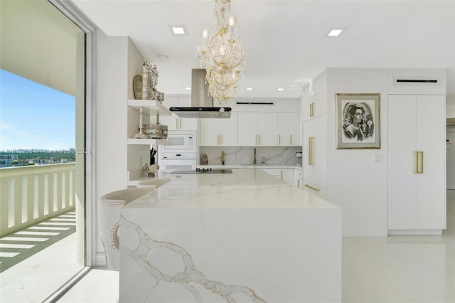 kitchen with hanging light fixtures, white appliances, modern cabinets, and white cabinetry