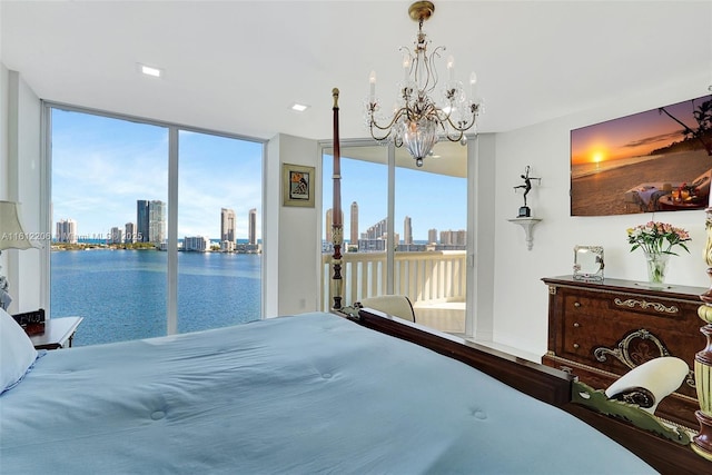 bedroom featuring a view of city, access to outside, floor to ceiling windows, and multiple windows