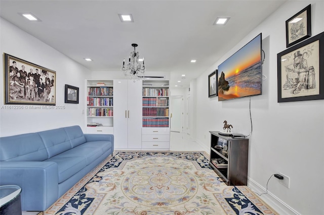 living room with built in shelves, recessed lighting, baseboards, and an inviting chandelier