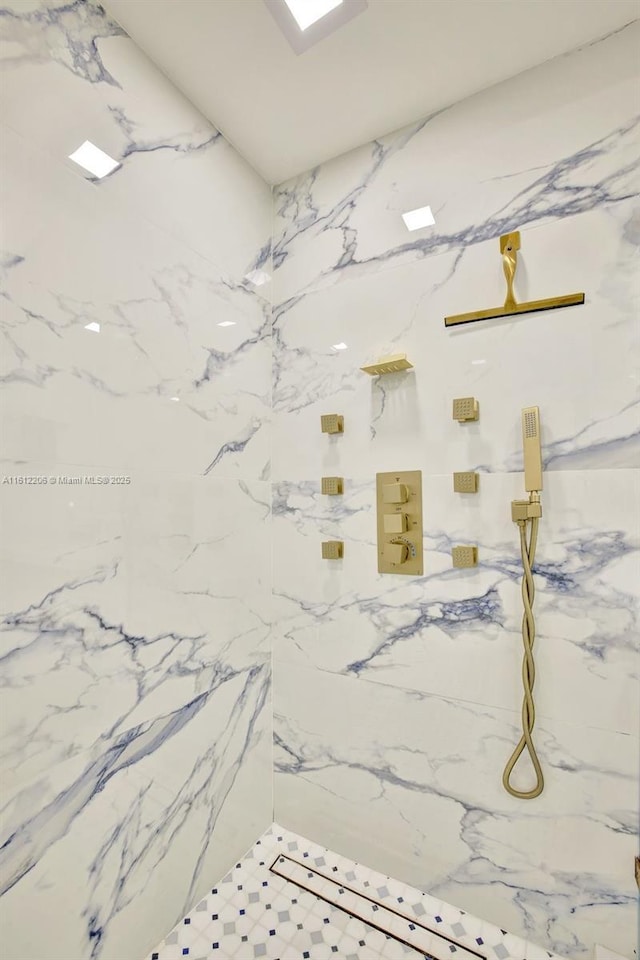 full bath with a marble finish shower