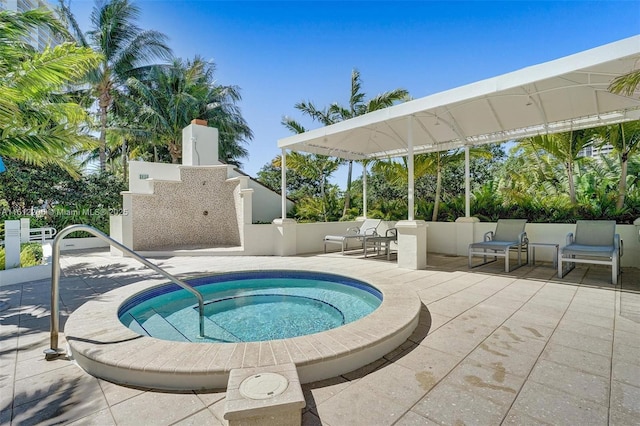 view of pool with a patio area and a hot tub