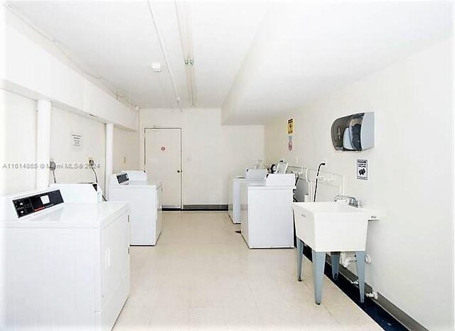 clothes washing area with washing machine and dryer