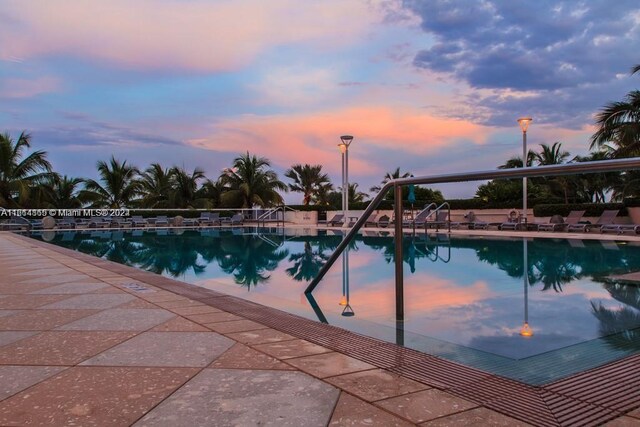 view of pool at dusk