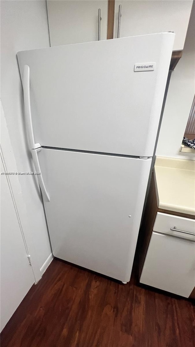 interior space featuring dark wood-type flooring and white refrigerator